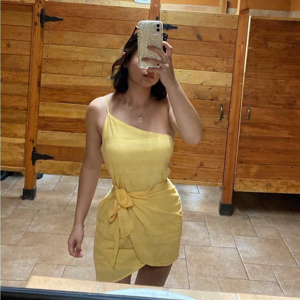 Dress With a single strap and loose bow at the hip.